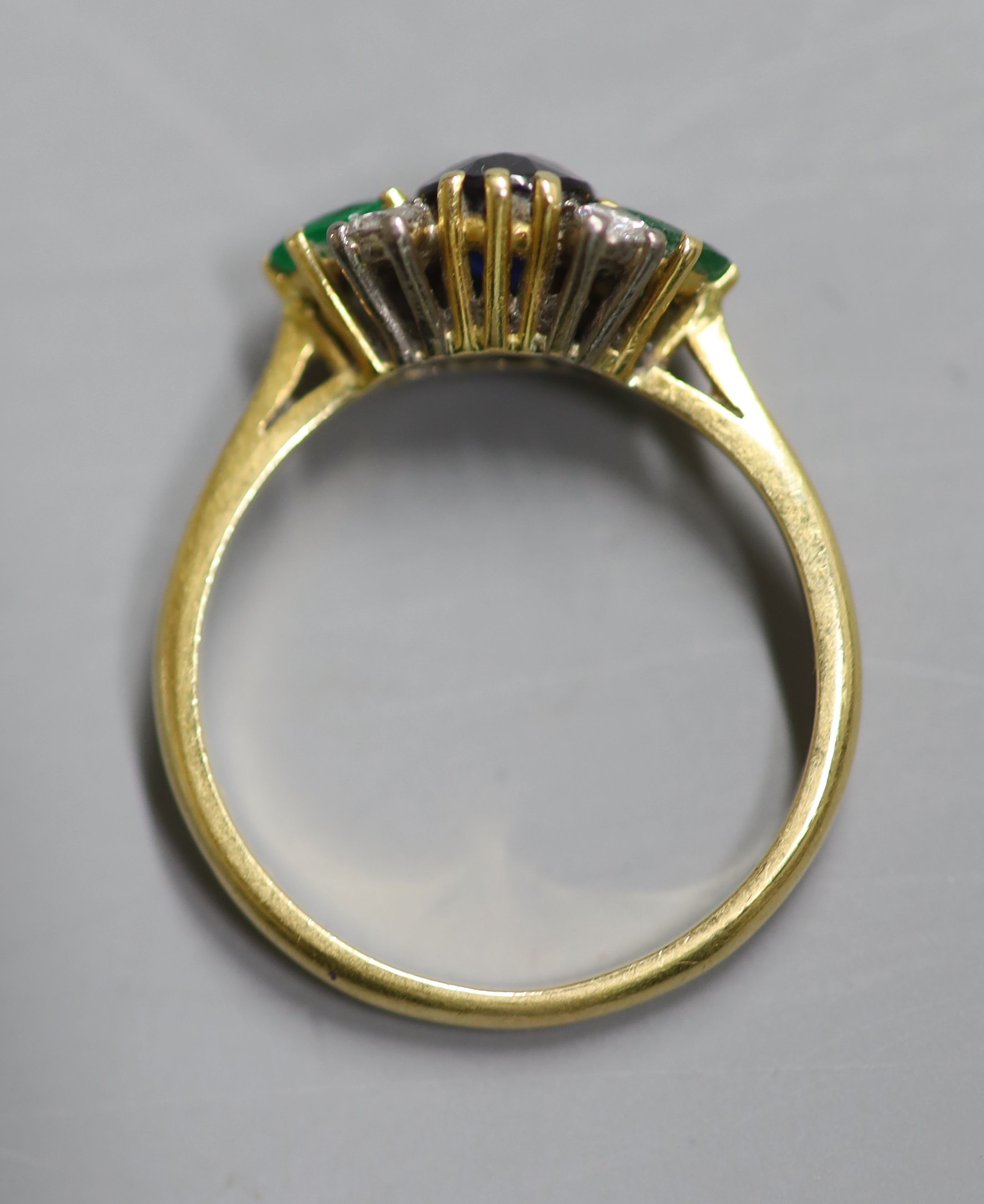 A 1970s 18ct gold, sapphire, emerald and diamond cluster ring, size P/Q, gross 3.2 grams.